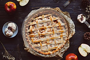 Homemade delicious apple pie with ice cream on the wooden table.