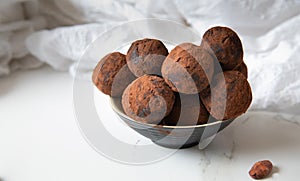 Homemade delicious Cocoa balls: chocolate balls cakes in a black plate against white background