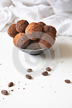 Homemade delicious Cocoa balls: chocolate balls cakes in a black plate against white background