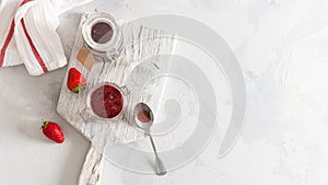 Homemade delicious strawberry jam and strawberry on a rustic wooden board. Top view, copy space. Cookbook recipe. Preserve food.