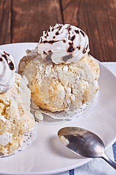 Homemade desserts with meringue, prunes and butter cream