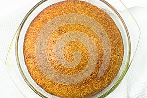 Homemade dietary bread of amaranth and spelt whole grain flour. Fresh baked bread in glass baking dish top view.