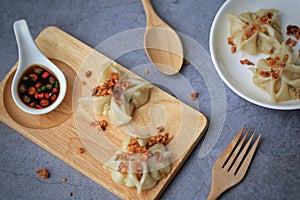 Homemade Dim sum top up with fried garlic and coriander on cement table background