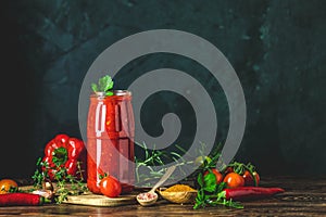 Homemade DIY natural canned hot tomato sauce chutney with chilli or adjika