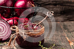 Homemade DIY natural healthy red onion marmalade jam, confiture, chutney in jar. Vegetable jam on wooden background. French