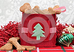 Homemade dog cookies in a decorative Christmas bag.