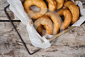 Homemade donuts with icing sugar powder on wooden background