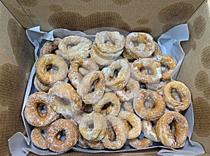 Homemade donuts inside a cardboard box