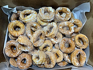 Homemade donuts inside a cardboard box