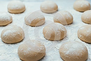 Homemade dough pies on the baking sheet ready for the oven for baking