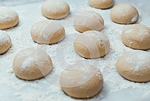 Homemade dough pies on the baking sheet ready for the oven for baking