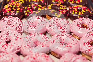 Homemade doughnuts with chocolate and strawberry icing