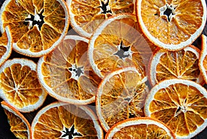 Homemade dried fruits slices of orange grapefruits food pattern on dark background