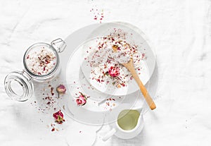 Homemade edible coconut rose sugar scrub on light background, top view. Making home product cosmetics concept