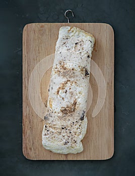 Homemade egg white wraap stuffed with chicken breast and truffle sauce on wooden chopping board