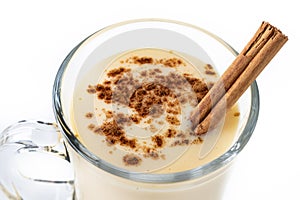 Homemade eggnog with cinnamon isolated on white background