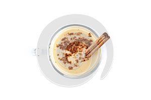 Homemade eggnog with cinnamon isolated on white background.