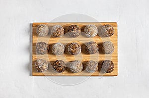 Homemade energy balls with dried apricots, raisins, dates, prunes, walnuts, almonds and coconut. Healthy sweet food. Copy space.