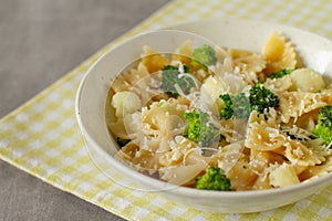 Homemade farfalle pasta with broccoli, cauliflower and parmesan