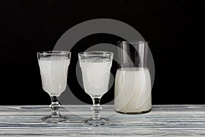 Homemade fermented alcoholic plant-based drink on dark background. Fermented beverages made by soaking grain, rice or fruits in