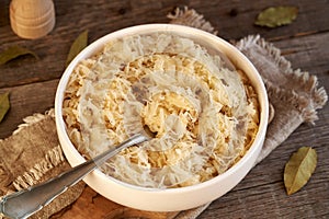 Homemade fermented cabbage or sauerkraut in a white bowl