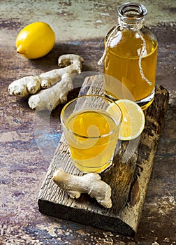 Homemade fermented raw ginger lemon kombucha tea. Healthy natural probiotic flavored drink. Copy space.