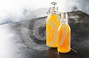 Homemade Fermented Raw Kombucha.Tea Ready to Drink. Gray Kitchen Table Background With Copy Space photo