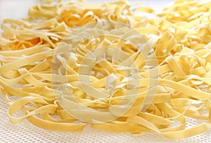 Homemade Fettucini on Drying tray. Macro with selective focus photo