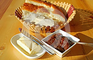 Homemade fig jam and butter with blurry basket of Armenian breads in the backdrop