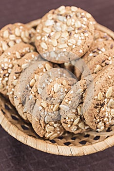 Homemade fitness cookies with cereals and sunflower seeds lies in a wicker basket