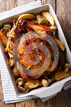 Homemade food: baked chicken with mushrooms and potatoes close-up. vertical top view