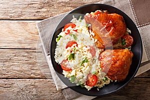 Homemade food: baked chicken thighs with garnish of rice close u