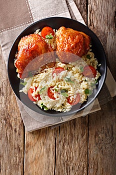 Homemade food: baked chicken thighs with garnish of rice close u