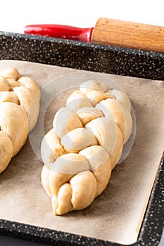 Homemade food concept process proved bread braid challah dough on white background with copy space