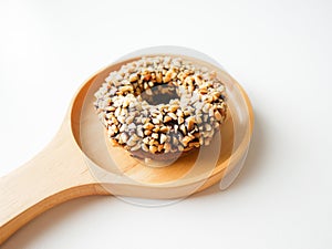 Homemade food fresh bakery, Closeup delicious chocolate donut almond peanut topping served on wooden dish