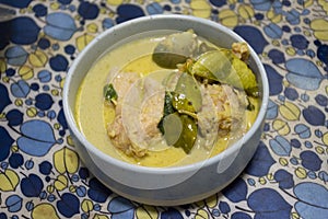 Homemade food thai style green curry with grey fishballs, coconut milk and chillies in bowl