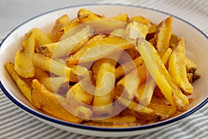 Homemade French Fries on a Plate, side view. Close-up