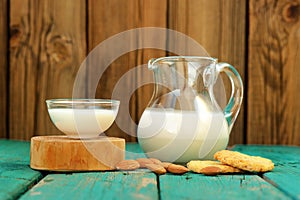 Homemade fresh almond milk in glass jar and glass bowl, with hom