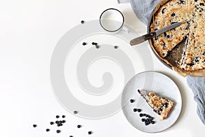 Homemade fresh baked blueberry pie. Berries, mug of milk and linen napkin isolated on white table background. Delicious