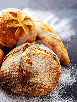 Homemade fresh bread on the dark table