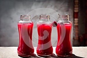 Homemade fresh cherry juice in a glass bottle