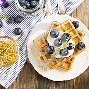 Homemade fresh crispy waffles for breakfast with blueberries