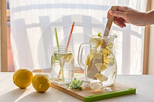 Homemade fresh lemonade pitcher, preparation of lemonade