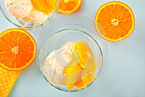 Homemade fresh orange ice cream with orange slices. Summer dessert.