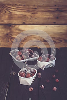 Homemade fresh yogurt. Healthy sweet dessert on dark rustic wood. Frozen fruits