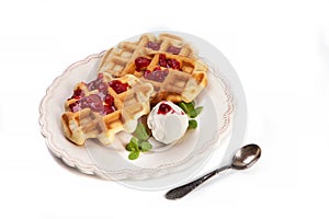 Homemade freshly baked belgian waffles with mascarpone, mint leaves and strawberry sauce isolated on white background