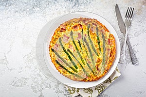 Homemade, freshly baked vegetable frittata with green asparagus and bacon photo