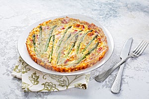 Homemade, freshly baked vegetable frittata with green asparagus and bacon photo