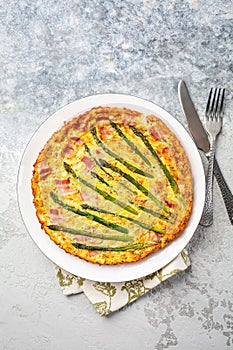 Homemade, freshly baked vegetable frittata with green asparagus and bacon photo