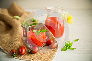 homemade freshly squeezed tomato juice with pulp in a glass decanter